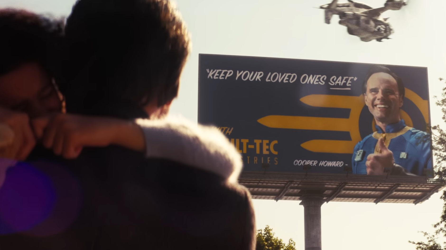 Cooper Howard with his daughter, looking up at his face on a promotional billboard for the dangerous mega-corporation, Vault-Tec.