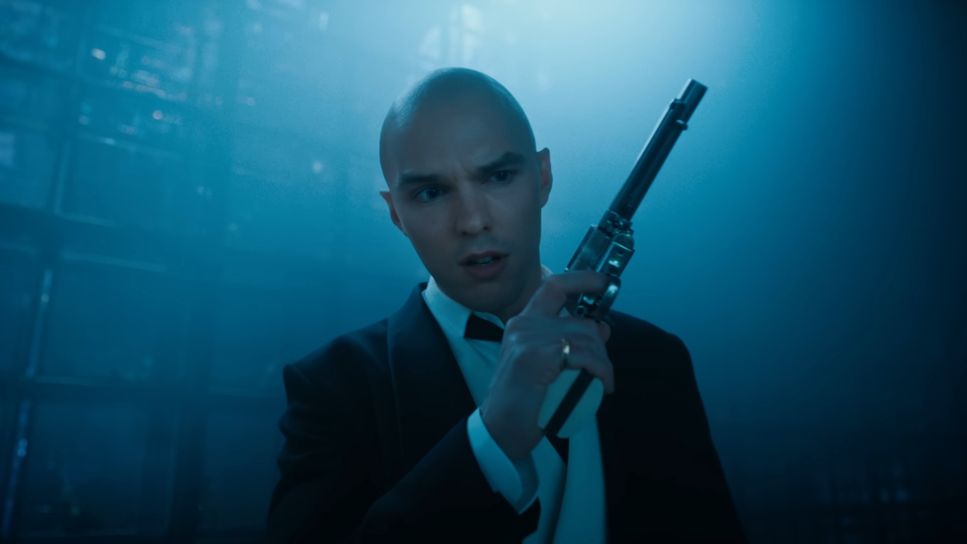 Lex Luthor, played by Nicholas Hoult, holding a gun, presumably facing Superman