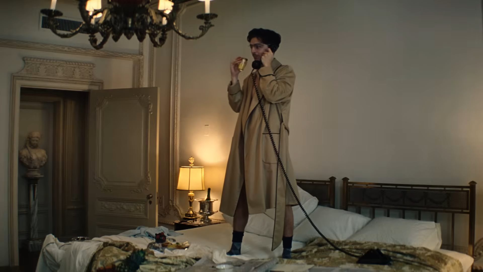 Marty standing on his hotel suite bed, calling Kay Stone.