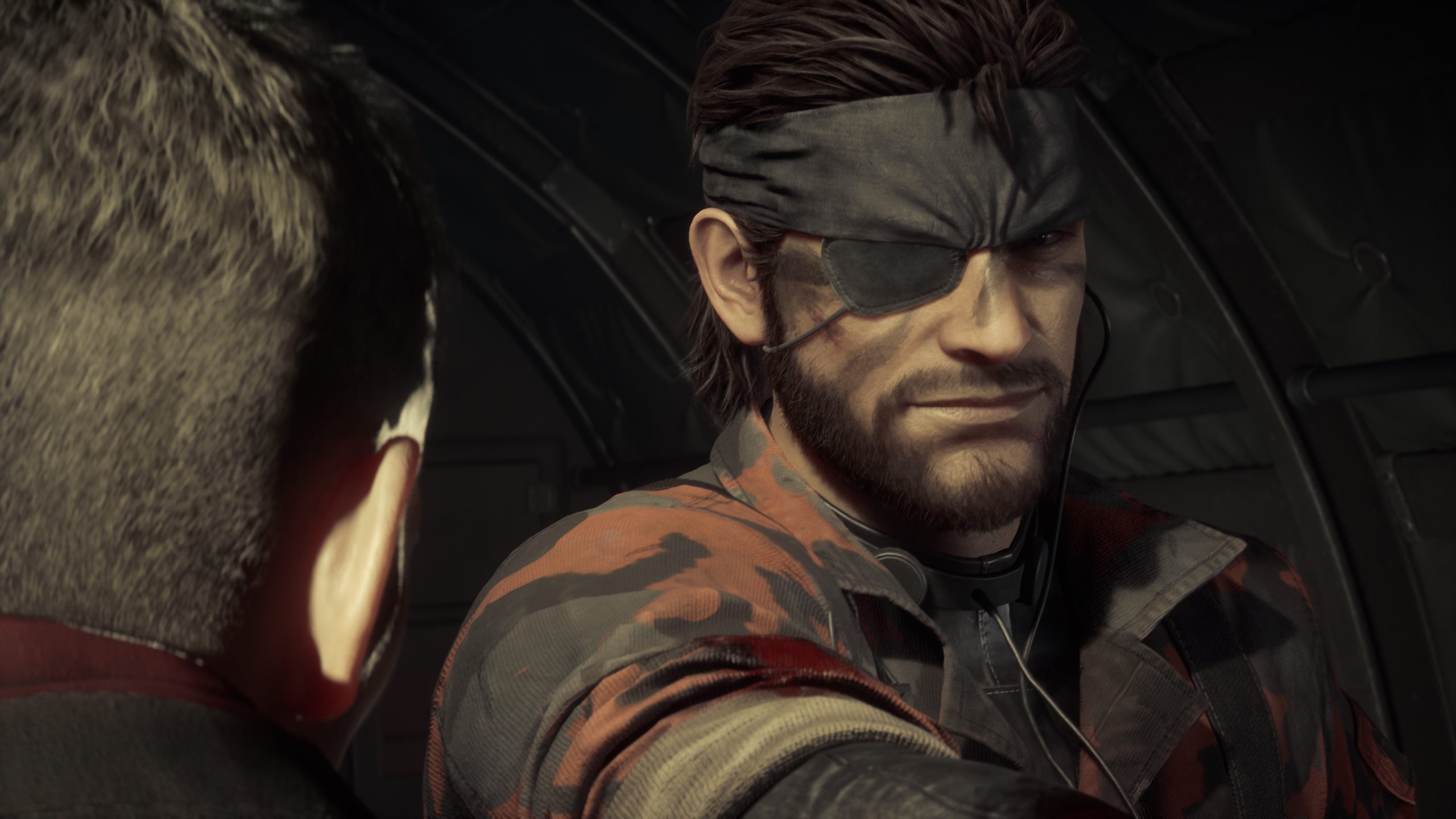 Naked Snake smiling at Ocelot, who finds great interest in him as a dueling partner.